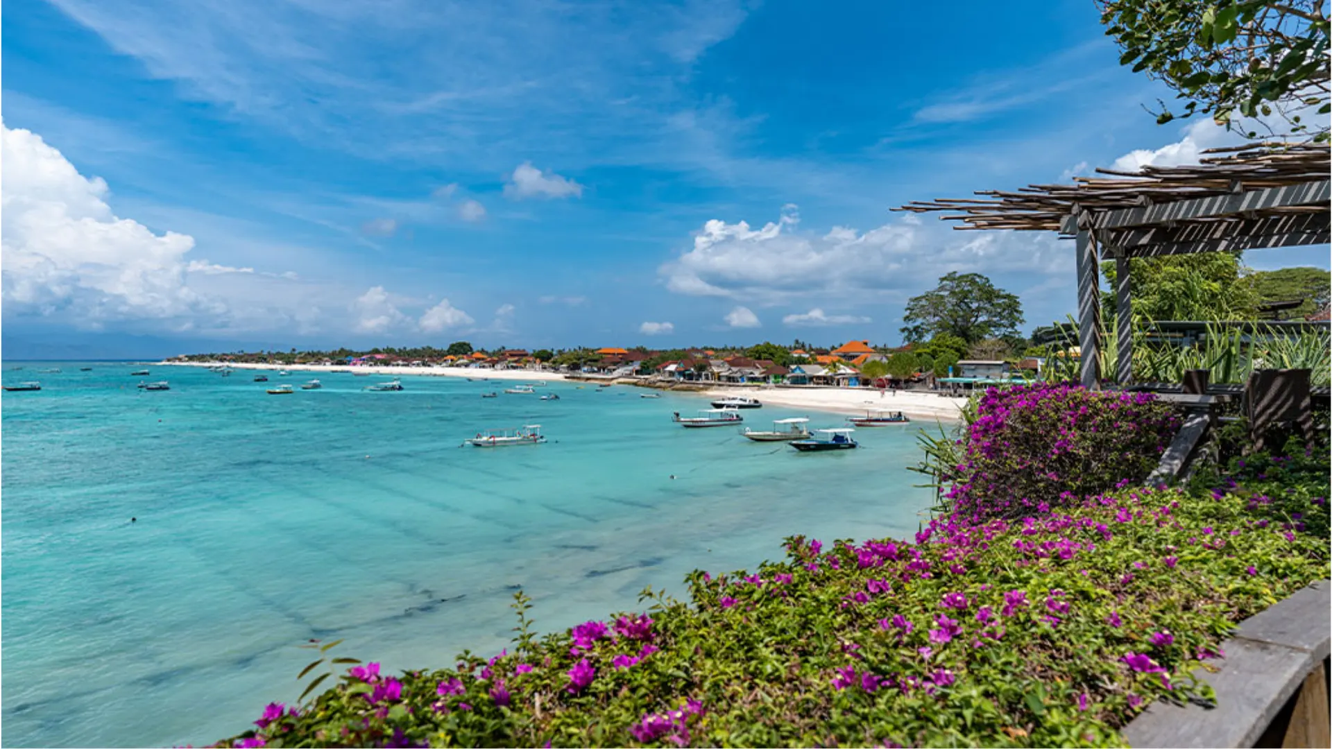 Coastline view of Jungut Batu Beach Nusa Lembongan showing local beachfront cafes and calm sea conditions.