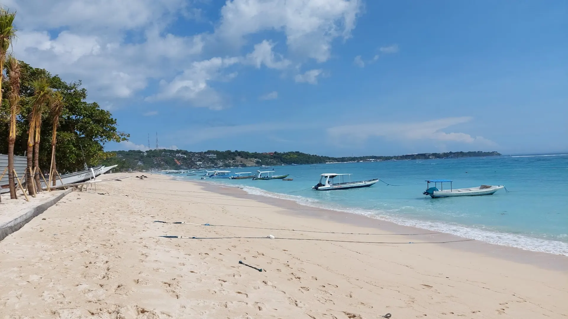 Turquoise ocean expanse and distant horizon seen from the main harbor area of Jungut Batu Beach Nusa Lembongan.