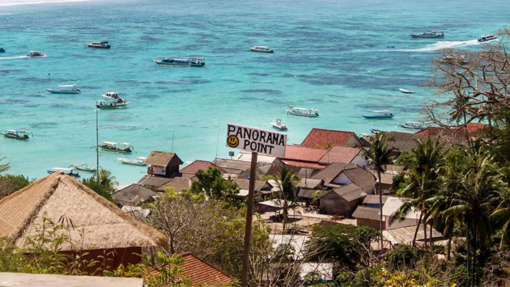Signboard at Panorama Point Nusa Lembongan overlooking the expansive harbor filled with boats.