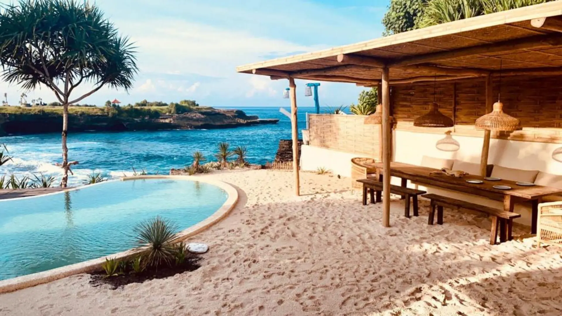 Beachfront wooden deck and outdoor seating area at Sandy Bay Beach Club Nusa Lembongan overlooking the ocean.