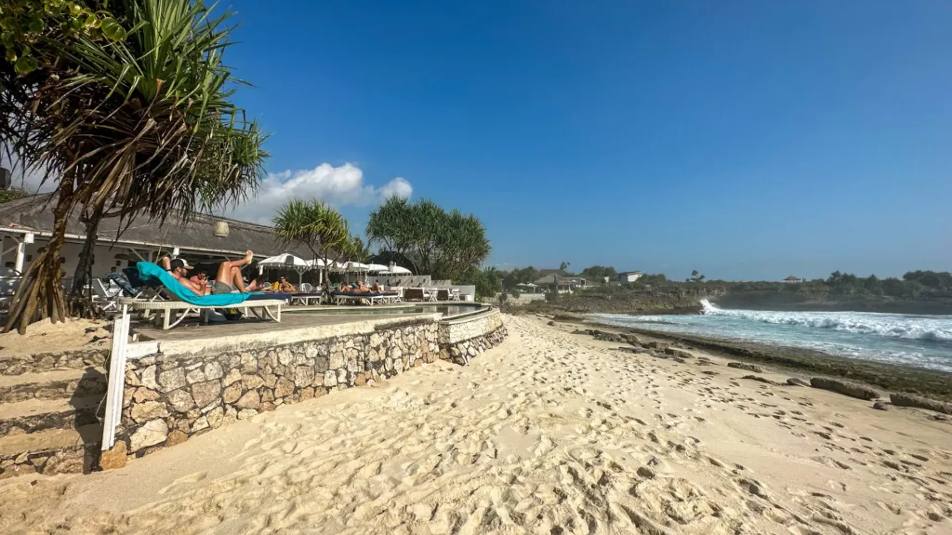 Cozy tropical garden and coastal path leading towards the entrance of Sandy Bay Beach Club Nusa Lembongan.