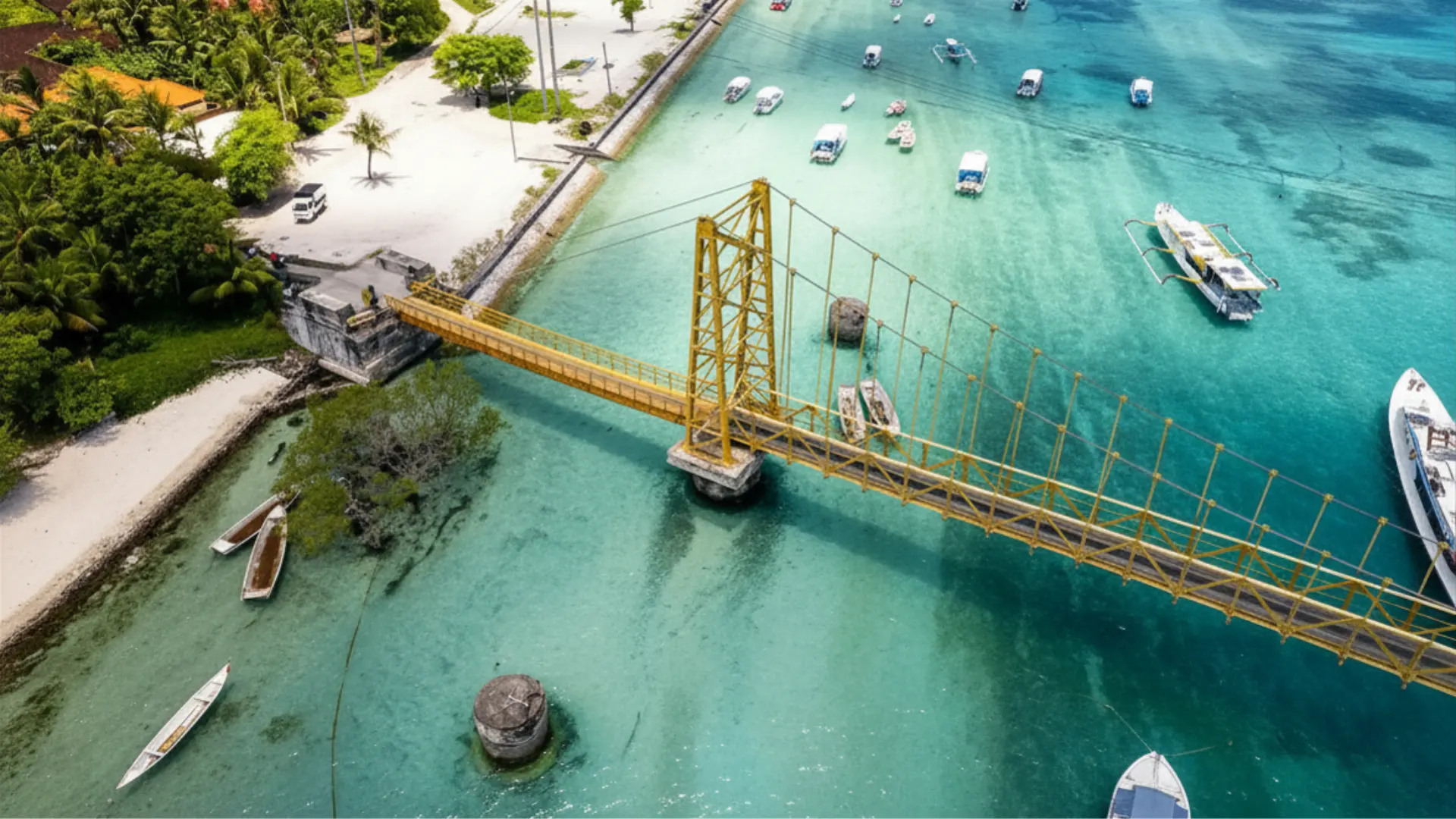 Aerial drone perspective of the Yellow Bridge Nusa Lembongan structure connecting the two tropical islands.